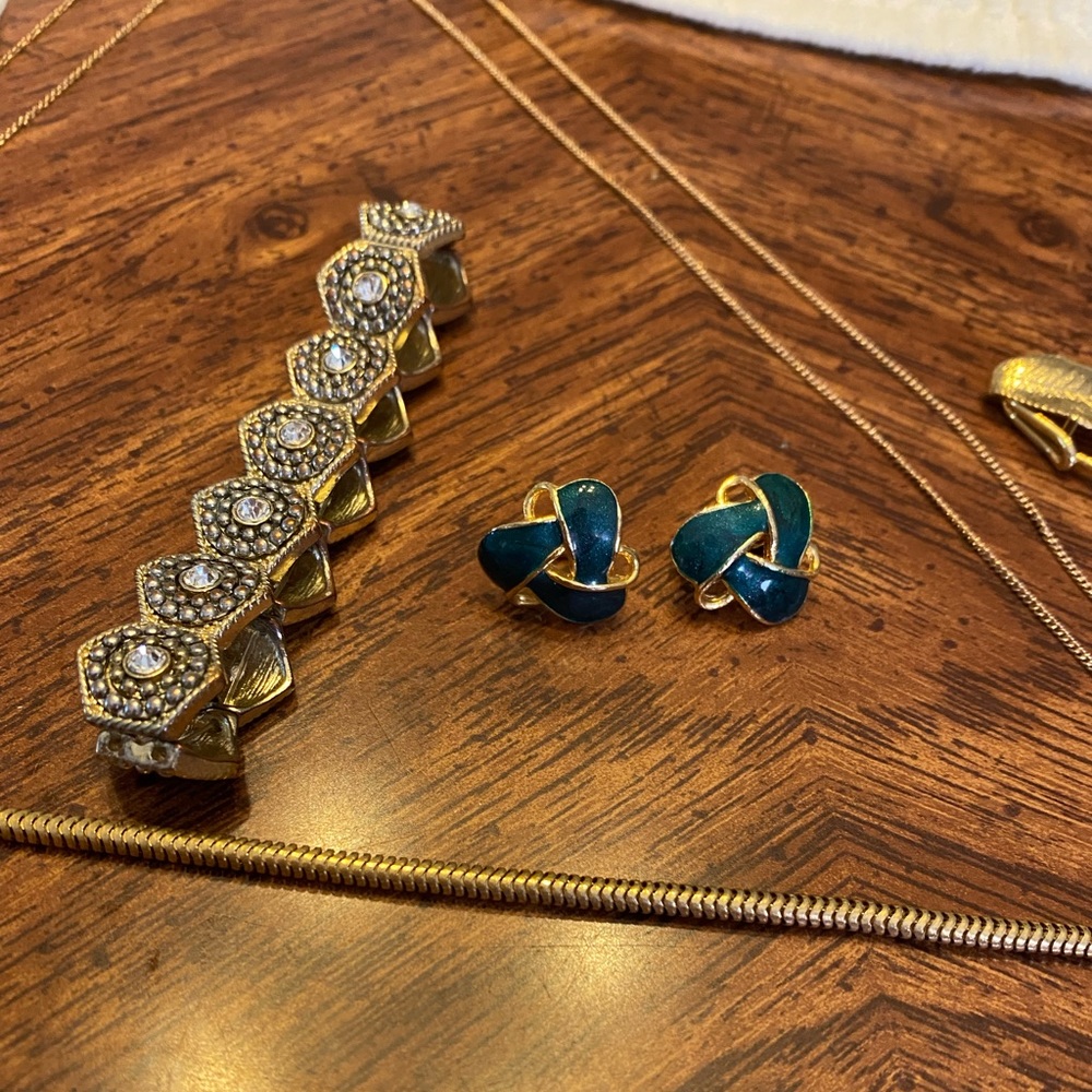 1 bracelet 2 necklaces a pair of clip earrings and a pin